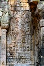 Scene of Khmer dancers on walls of Ta Prohm, Siem Reap, Cambodia. Temple wall art with demaged asparas, scarved dance ceremony