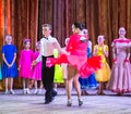 Dance school. Pupils take exams. Boys and girls in beautiful dance costumes on stage