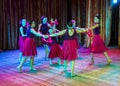 Dance school. Pupils take exams. Boys and girls in beautiful dance costumes on stage