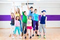 Dance teacher giving kids Zumba fitness class