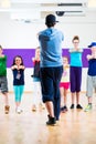 Dance teacher giving kids Zumba fitness class Royalty Free Stock Photo