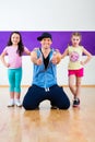 Dance teacher giving kids Zumba fitness class Royalty Free Stock Photo