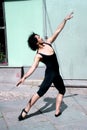 Dancer with black leotard and ballet tips