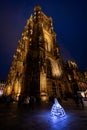 A dancer dancing in front of Strasbourg Cathedral at night