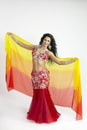 The dancer of east dances with bright scarfs fabrics Royalty Free Stock Photo