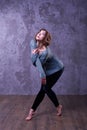 Dancer girl with short brown curly hair dance in the studio. Royalty Free Stock Photo