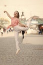 The dancer is at her best. Adorable street dancer. Little female dancer performing ballet leap on street. Small cute Royalty Free Stock Photo