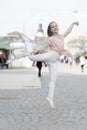 The dancer is at her best. Adorable street dancer. Little female dancer performing ballet leap on street. Small cute Royalty Free Stock Photo