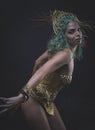 Dancer, Latin woman with green hair and gold costume with handmade flourishes, fantasy image and tale Royalty Free Stock Photo