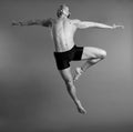 Dancer leaping over gray background Royalty Free Stock Photo