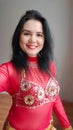 A dancer in a red suit is dancing an oriental dance on a white background. A professional dancer dances oriental belly Royalty Free Stock Photo