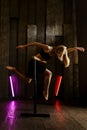 Dancer in studio, girl jumping and dancing, professional in black active wear Royalty Free Stock Photo