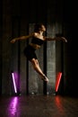 Dancer in studio, girl jumping and dancing, professional in black active wear Royalty Free Stock Photo