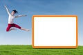 Dancer woman jumping with empty board Royalty Free Stock Photo