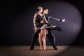 Dancers in ballroom on black background