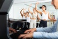 Dancers doing exercises on stretching ballet barre under live music Royalty Free Stock Photo