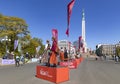 Dancers in Latvian national costumes stand on special platforms at the Rimi Riga Marathon 2023