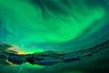 Dancing aurora over a glacier lagoon Royalty Free Stock Photo