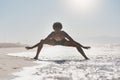 Dancing balances my life. Full length shot of a handsome young man performing a challenging dance sequence on the beach Royalty Free Stock Photo