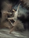 Dancing ballet dancer with dust in the background Royalty Free Stock Photo