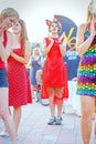 Dancing beautiful and elegant stylish girls participating in the carnival costumed women`s bike ride in the summer evening