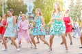 dancing beautiful and elegant stylish girls participating in the carnival costumed women`s bike ride in the summer evening Royalty Free Stock Photo