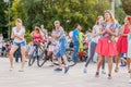 dancing beautiful and elegant stylish girls participating in the carnival costumed women`s bike ride in the summer evening Royalty Free Stock Photo