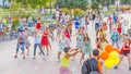 dancing beautiful and elegant stylish girls participating in the carnival costumed women`s bike ride in the summer evening Royalty Free Stock Photo