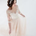 Dancing beautiful girl in a wedding dress. Bride in luxurious dress on a white background Royalty Free Stock Photo