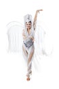 Beautiful young woman in carnival, stylish masquerade costume with feathers dancing on white studio background. Concept Royalty Free Stock Photo