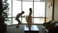 dancing couple against large window