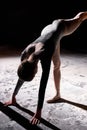 Dancing in flour. beautiful female dancer in dark studio. female making dance element Royalty Free Stock Photo