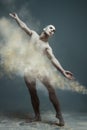 Long hair muscle man dancer in dust Royalty Free Stock Photo