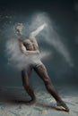 Long hair muscle man dancer in dust