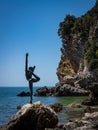 A dancing girl bronze sculpture on the rocky coast in Budva, Montenegro.