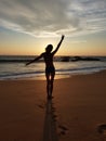 Dancing girl at sunset on the Indian Ocean