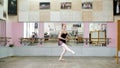 in dancing hall, Young ballerina in black leotard performs pas courru , pointe , She is moving through the ballet class