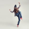 Dancing hipster girl in glasses and black beanie Royalty Free Stock Photo