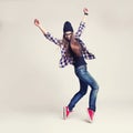Dancing hipster girl in glasses and black beanie Royalty Free Stock Photo