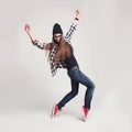 Dancing hipster girl in glasses and black beanie Royalty Free Stock Photo