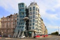 Dancing House in Prague with red tram in front