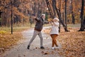 Dancing jumping in a park. Cheerful smiling senior man and woman having fun together Royalty Free Stock Photo