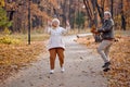 Dancing jumping in a park. Happy smiling senior man and woman having fun together Royalty Free Stock Photo