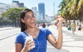 Dancing latin woman listening to music with phone