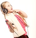 Dancing little girl headphones music singing on white background Royalty Free Stock Photo