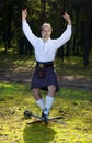 Dancing man in scottish costume with sword