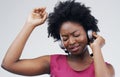 Dancing, music or happy black woman in headphones in studio for singing on grey background. Model, face or African girl Royalty Free Stock Photo