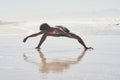 Dancing is my way of expressing myself. Full length shot of a handsome young man dancing shirtless on the beach during