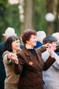 Dancing Pair In Years On Outdoor Dance Floor Among Dancing Solus Elderly People In Summer Amusement Park In Gomel