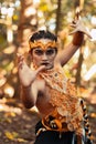 Dancing pose from a scary Balinese man with a golden necklace and crown on her body shirtless